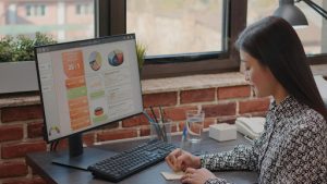Woman reviewing website analytics on a desktop computer.